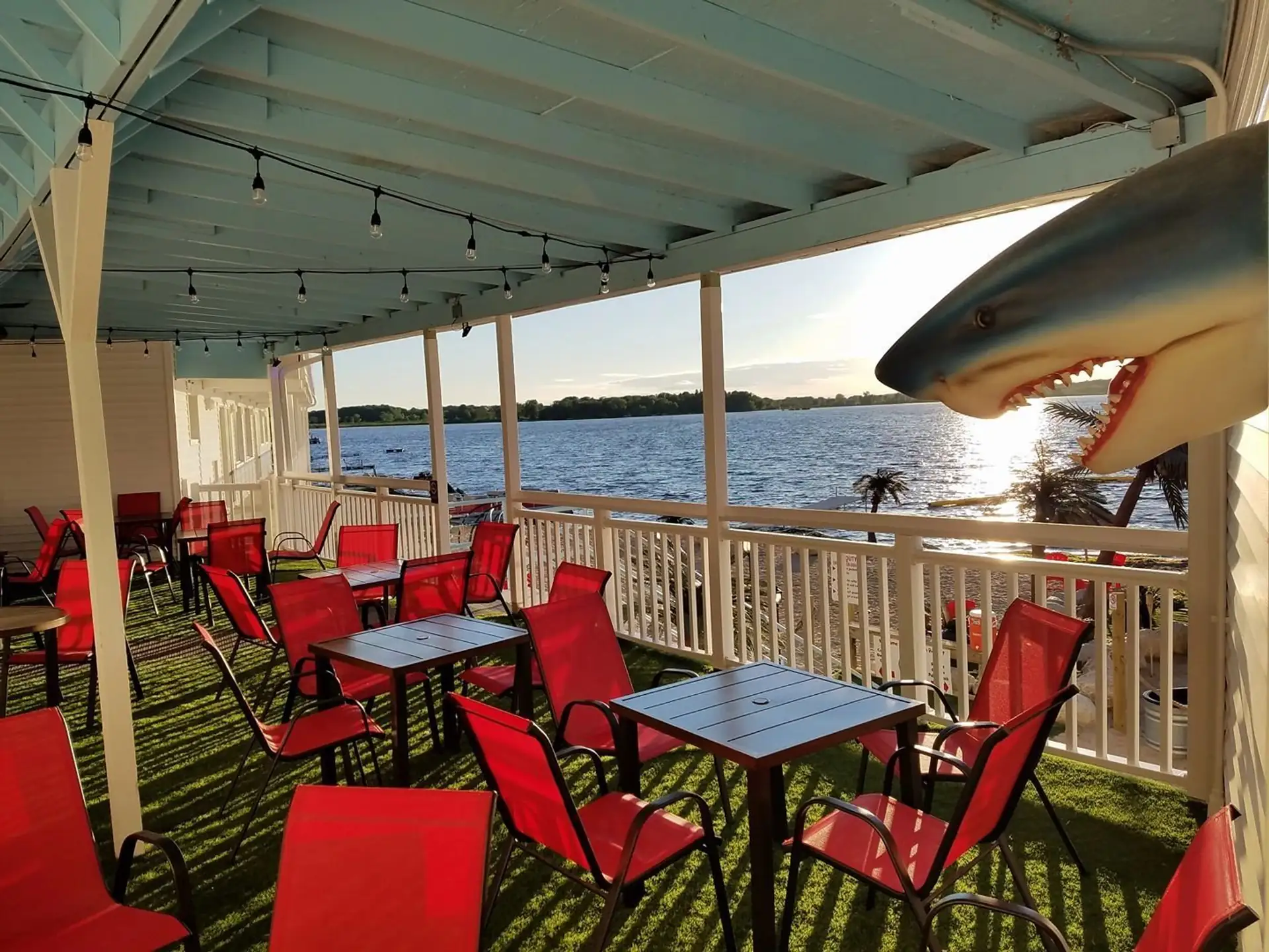 Balcony dining tables with the resident shark and the lake behind