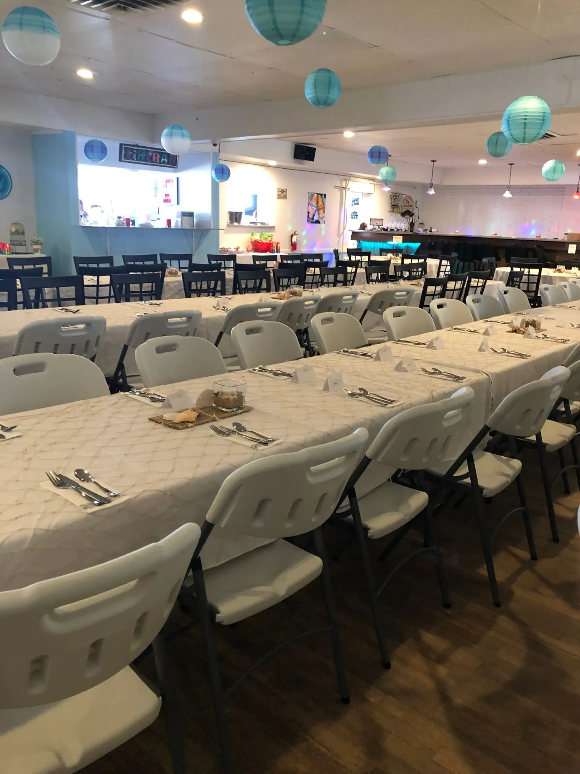 Banquet hall set with long white tables