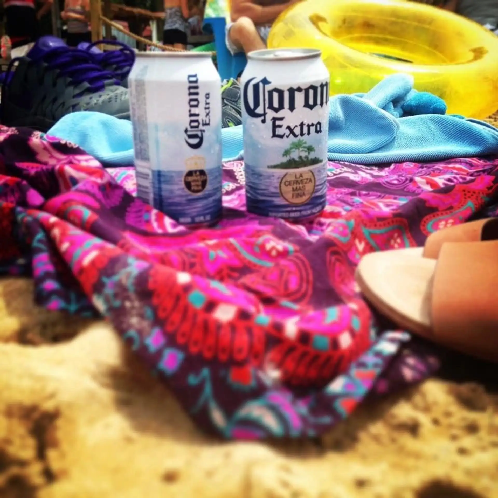 Cold beers on a beach towel in the sand