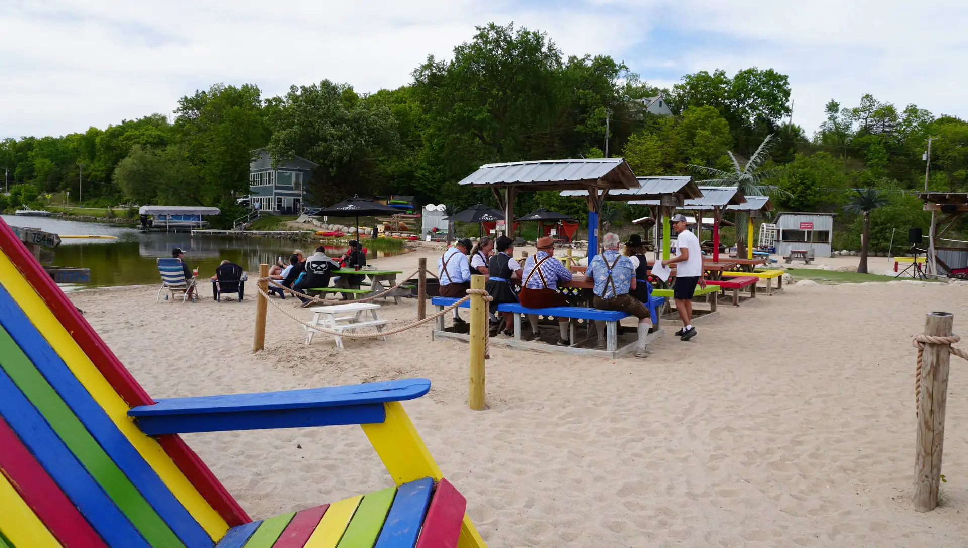 Guests at the colorful beach picnic tables on a summer afternoon