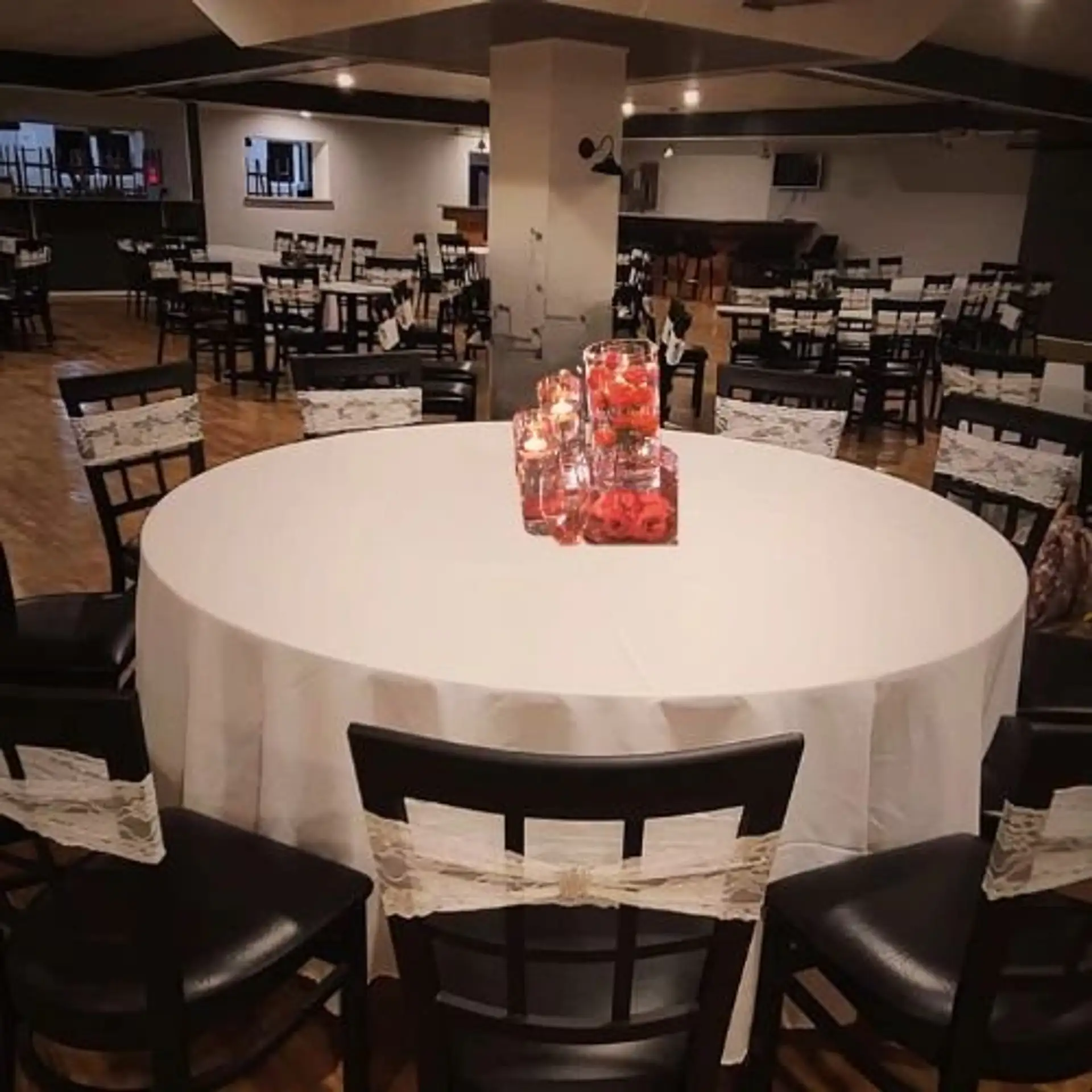 Wedding round-table setup with candle centerpieces